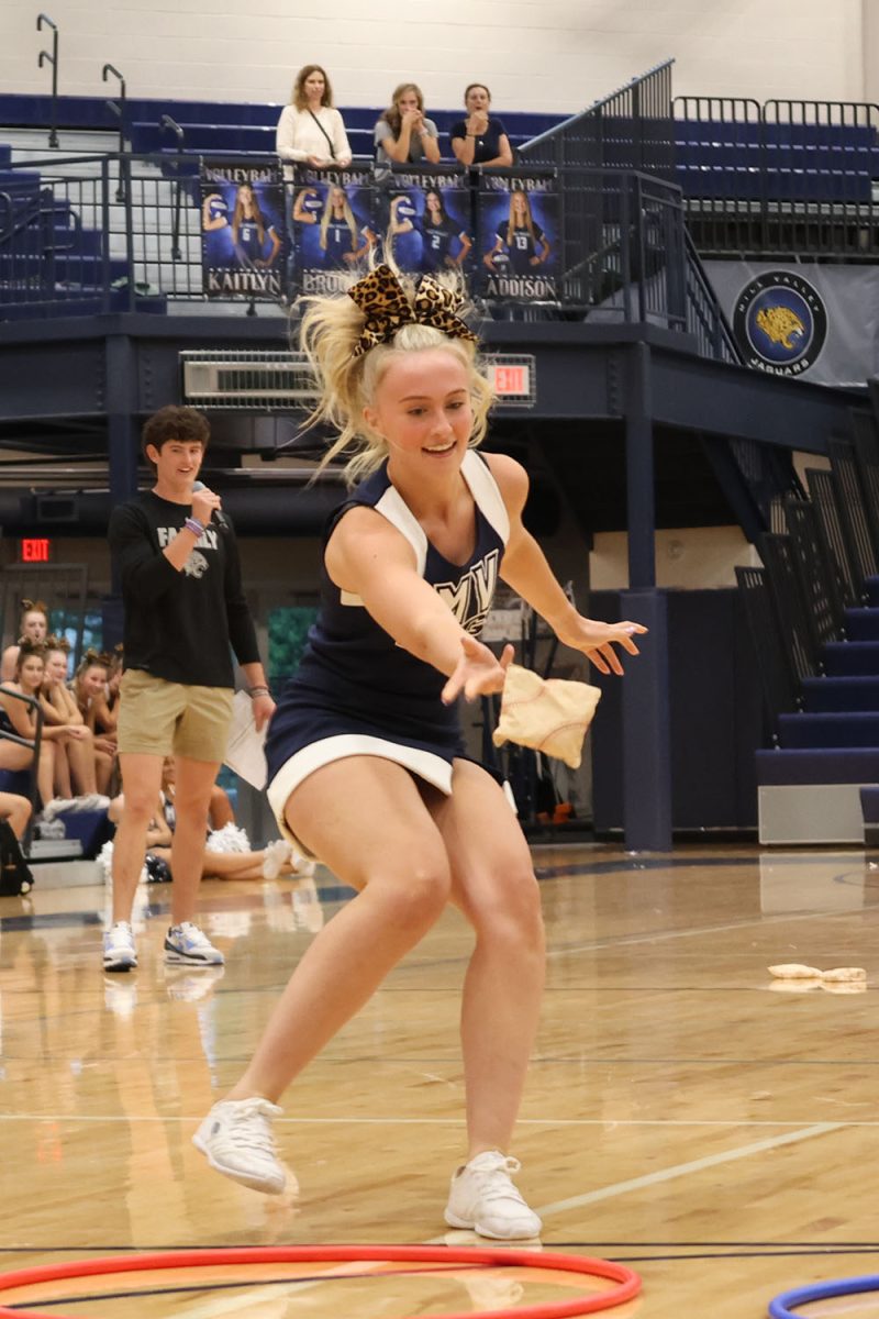 Tossing the bean bag, Homecoming candidate senior Olivia Moore works to win Tic-Tac-Toe.