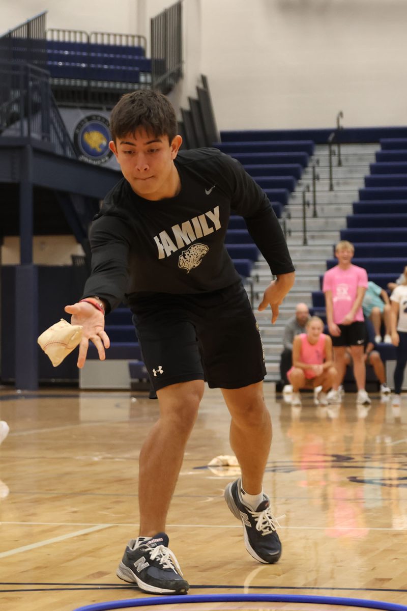 Focused, senior Walt Midyett tosses the bean bag onto the Tic-Tac-Toe board.