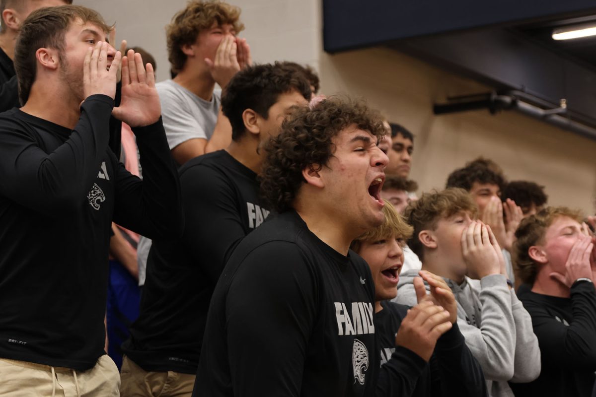 During the class chant competition, junior Abram Shaffer yells with his friends as loud as he can.