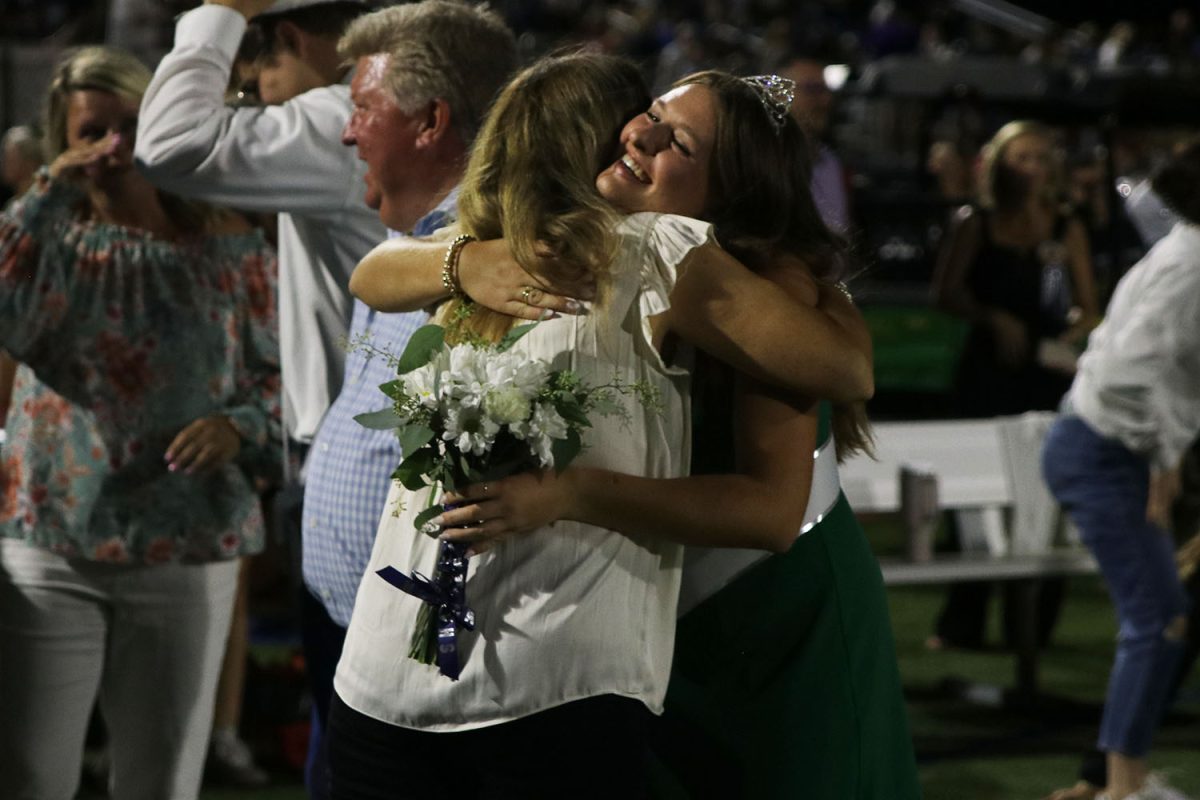 Senior Lucy Roy embraces a hug with her mom after being crowned the 2023 homecoming queen.
