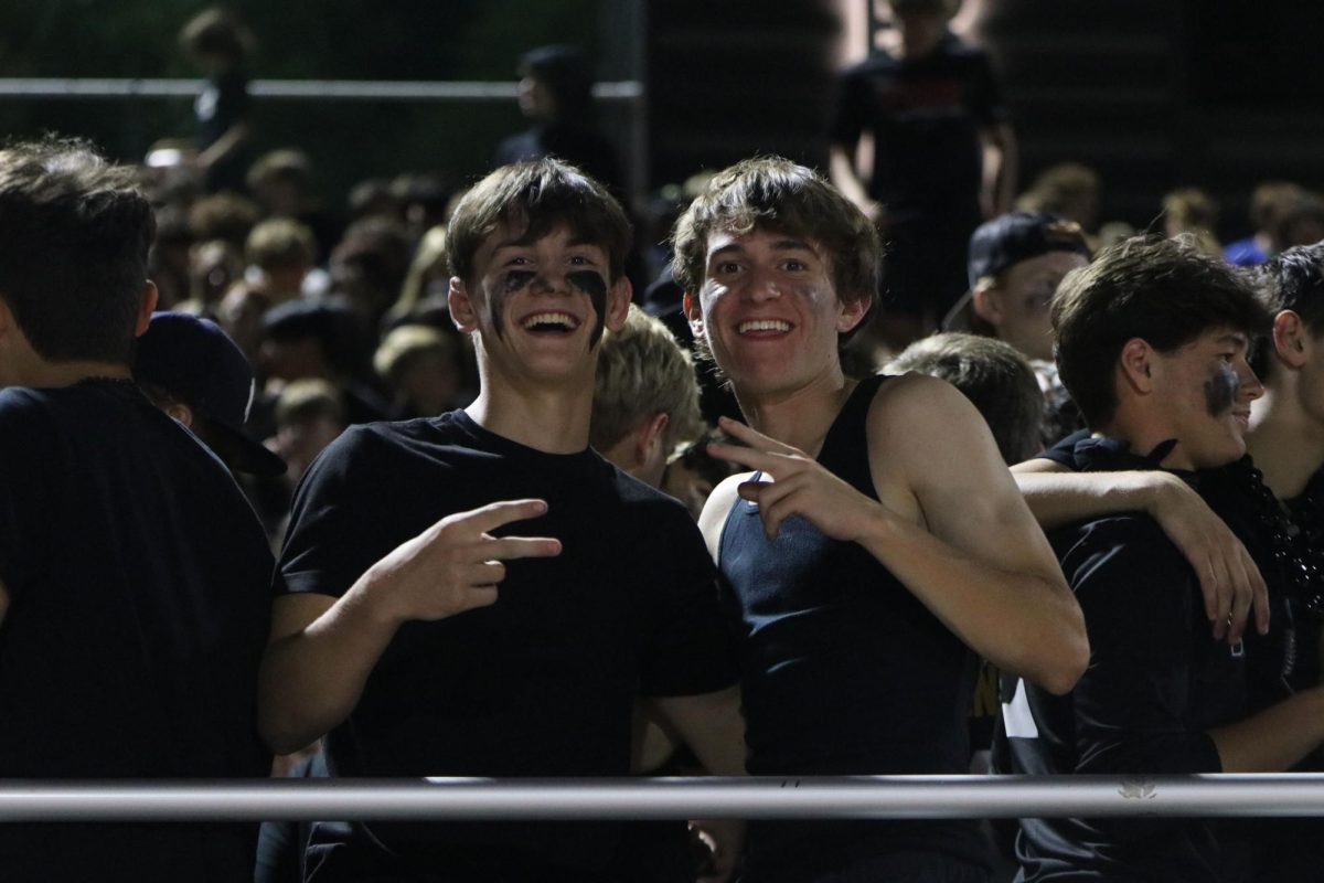 Seniors Dillon Cooper and Kyan Carroll show off their midnight ink at the homecoming football game.