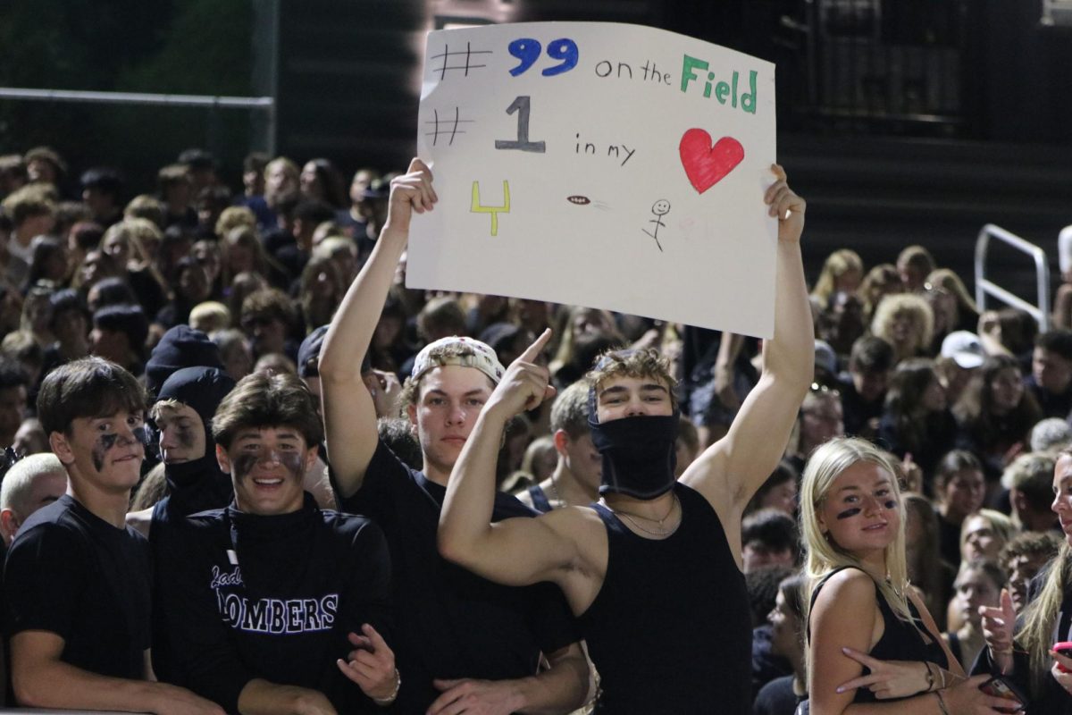 Here to support, seniors Hayden Albertson and Brady Mason show off their impeccable sign