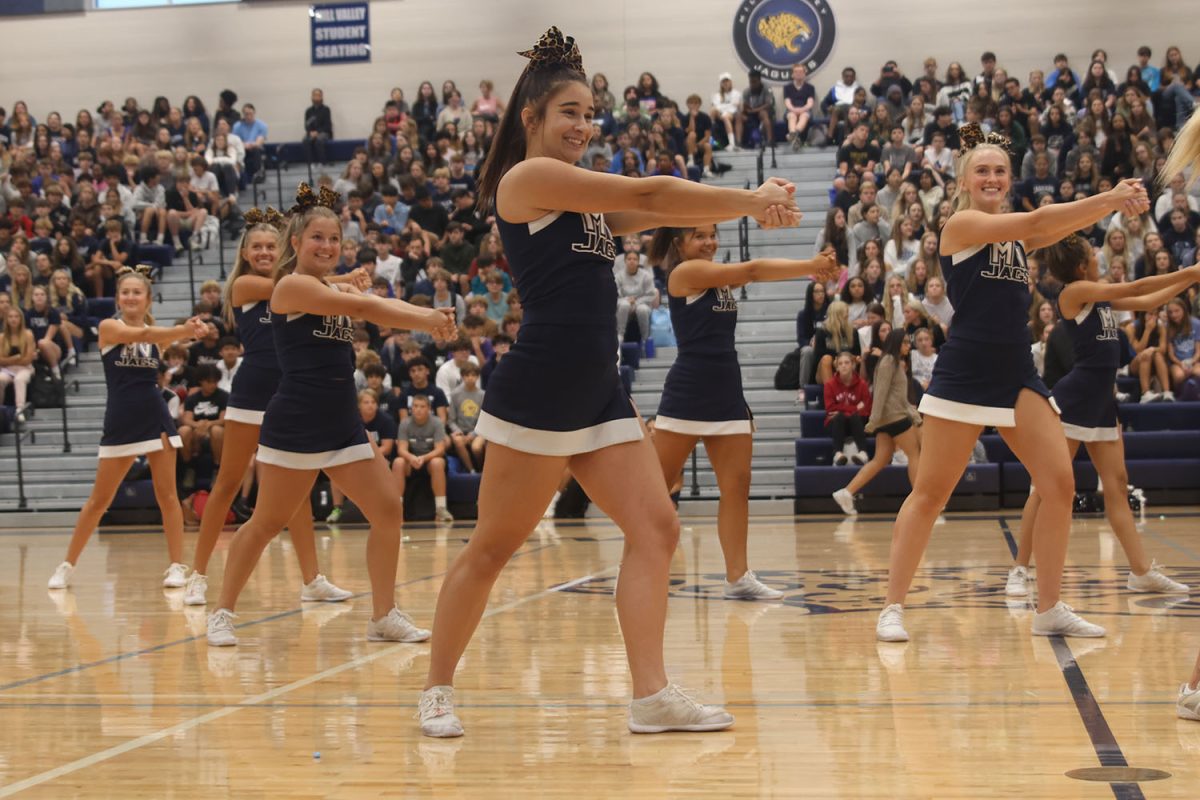 Striking a pose, senior Makenna Payne performs with the cheer team.