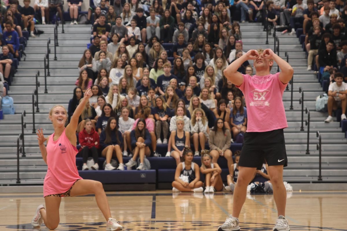 To end their handshake, senior Homecoming candidates Addison Bailey and Preston Fischer look towards the sky.