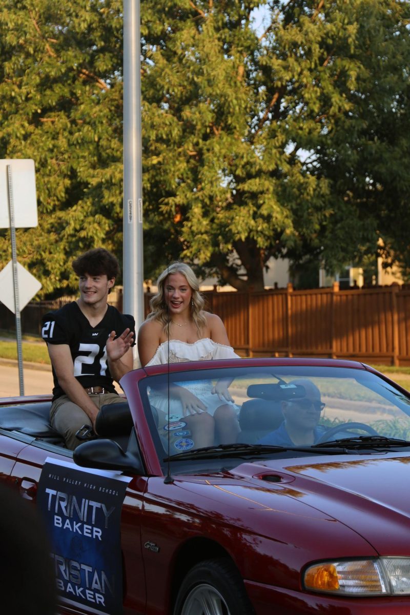 Homecoming candidates, Trinity Baker and Tristan Baker wave at the crowd during the parade.