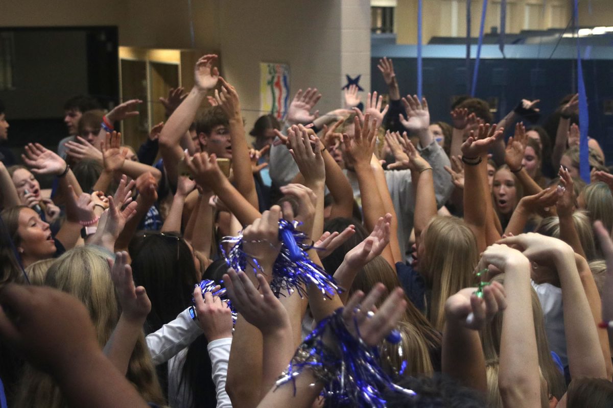 Everybodys hands go up while singing and dancing to the music.