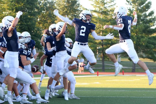 After the coin toss, seniors Tristan Baker and Jake Fischer jump and lock arms for the pregame hype ritual.