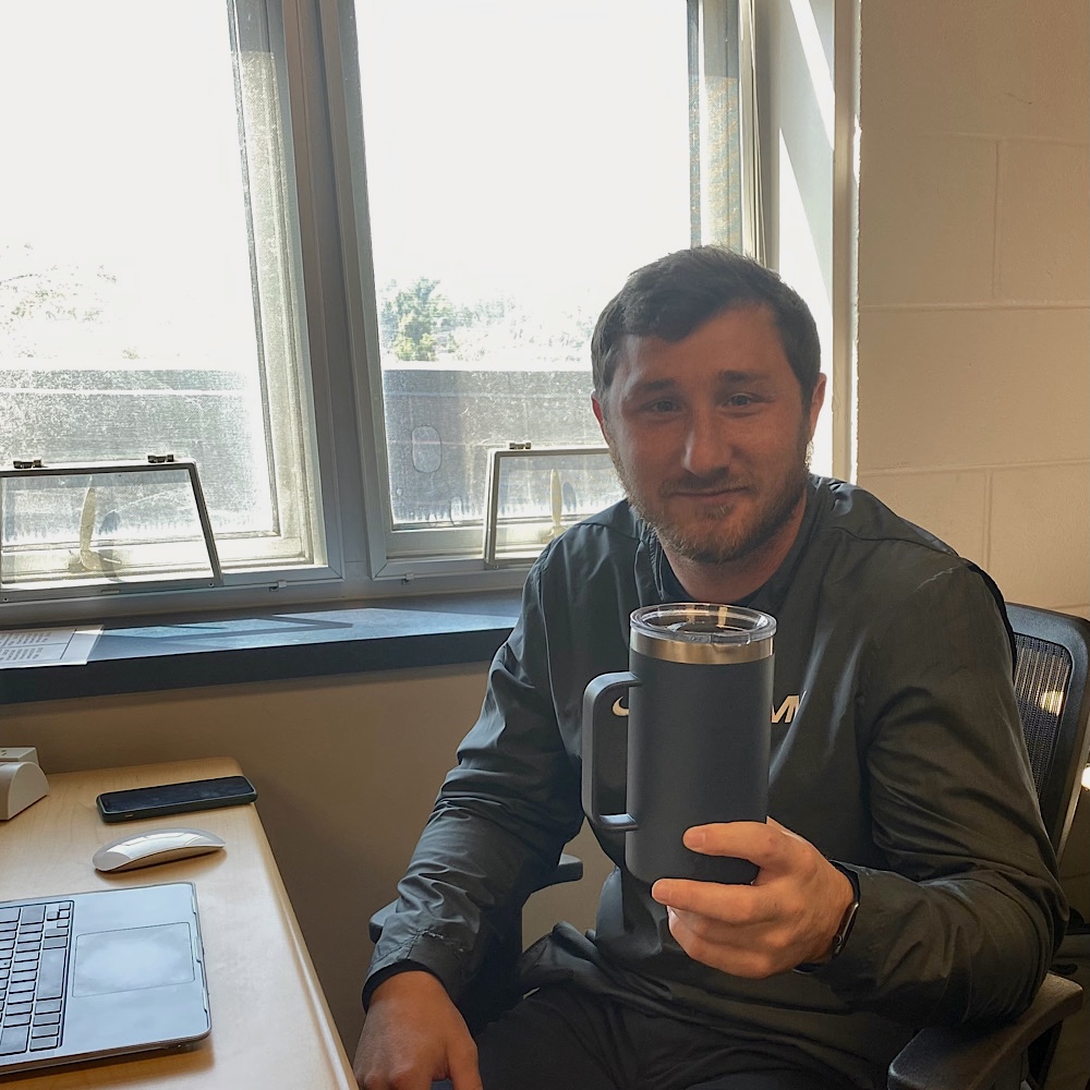 FOCUS teacher Drew Sachen holds his Yeti cup at his desk Tuesday, Sep. 12. [My Yeti cup] was the first gift anybody gave me as a teacher, Sachen said.