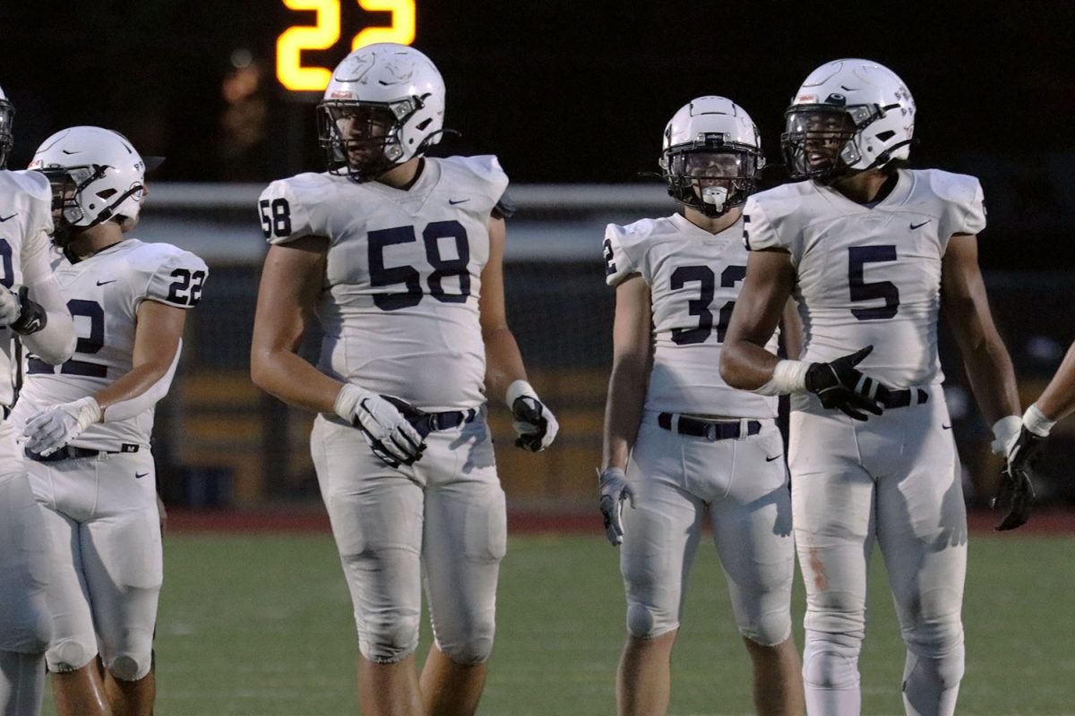 Looking for the play call, juniors Abram Shaffer and Jayden Woods look towards the sideline.