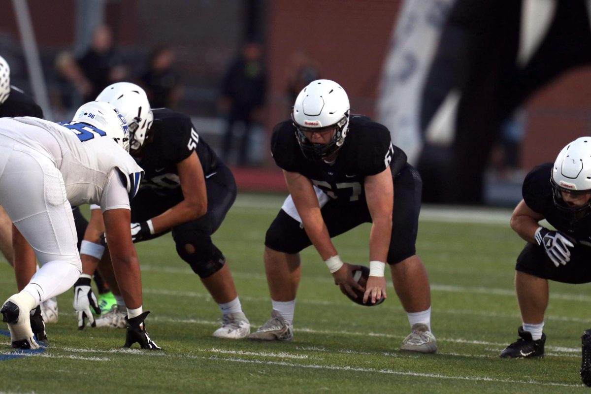 Snapping the ball, senior Jack Fulcher starts the first drive. 