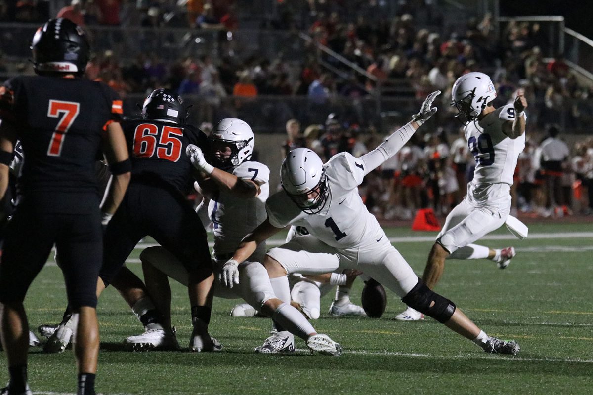 After the second touchdown, senior Cooper Schreiber blocks the opponent from reaching senior Kenten Laughman during the extra point attempt.
