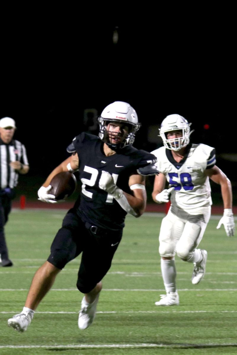 Running toward the endzone, senior Jaden Scoobe attempts to get a touchdown. 