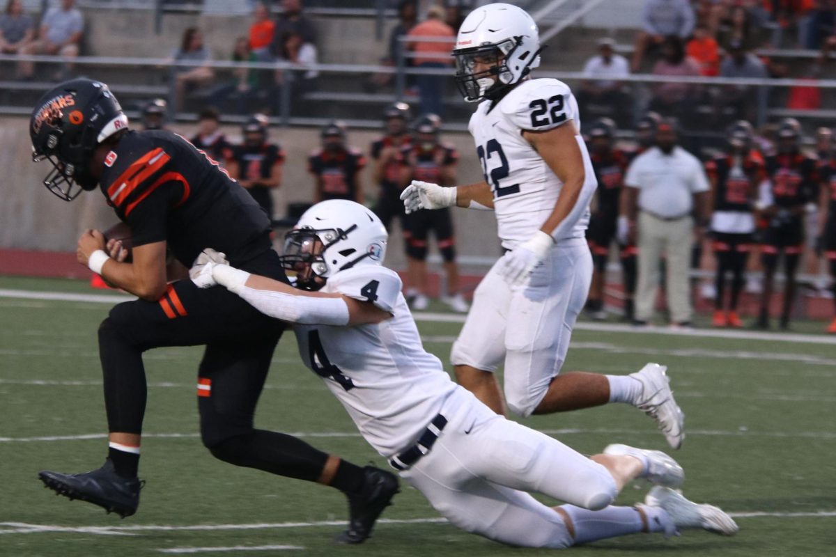 Sophomore Dylan Everhart brings down his opponent. 