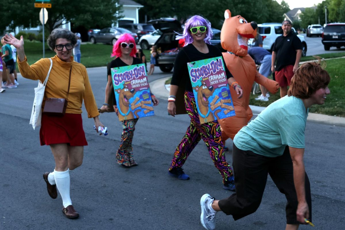 Repping Scooby-Doo outfits, the lunch ladies make their appearance by waving to the crowd. 