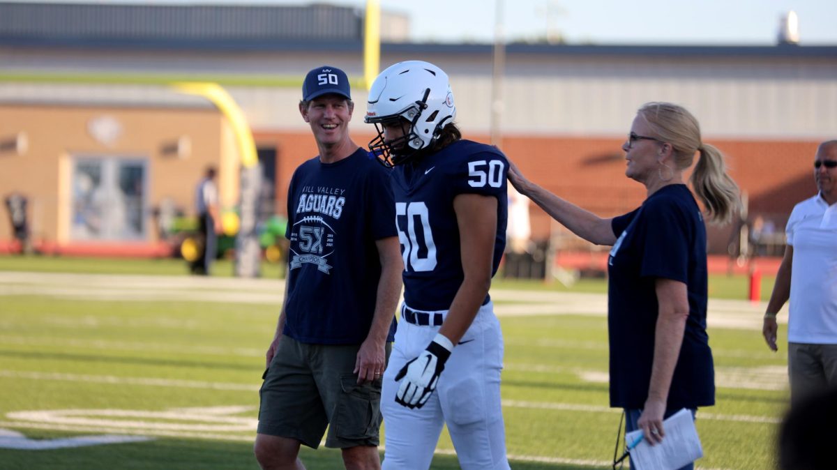 After stopping to address principal Dr. Gail Holder, senior Sully Suderman walks in during Senior Night.