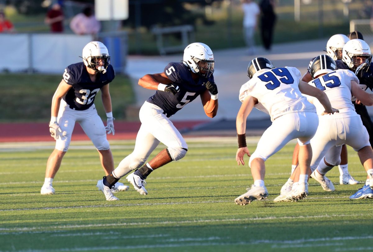 Junior Jayden Woods runs towards the offense.