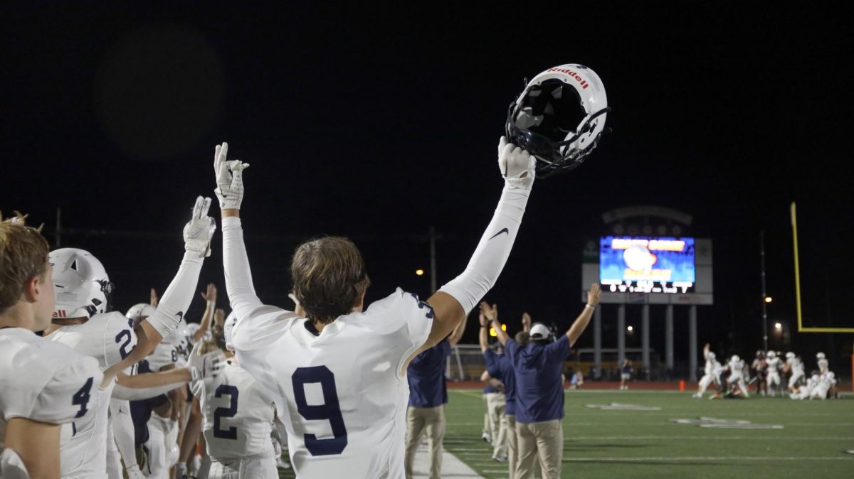 After a score, senior Lincoln Gray puts his hands up in celebration.