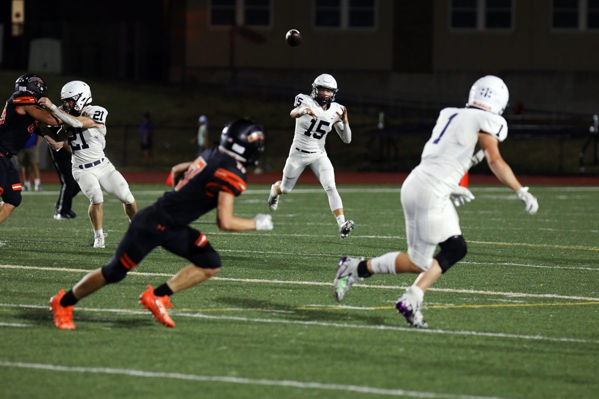 Senior Daniel Blaine passes the ball to senior Cooper Scheriber.