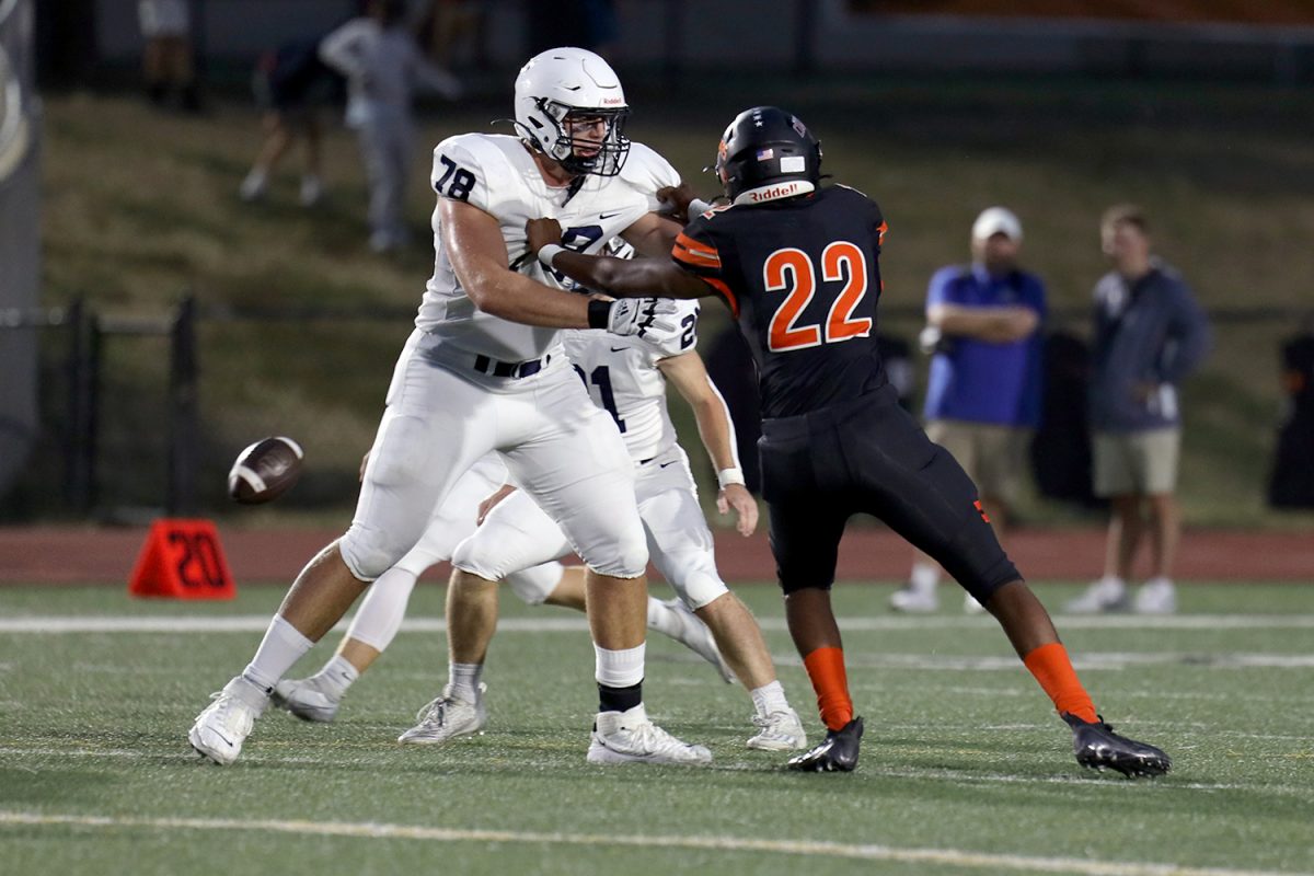 Senior Gus Hawkins pushes against an opponent. 
