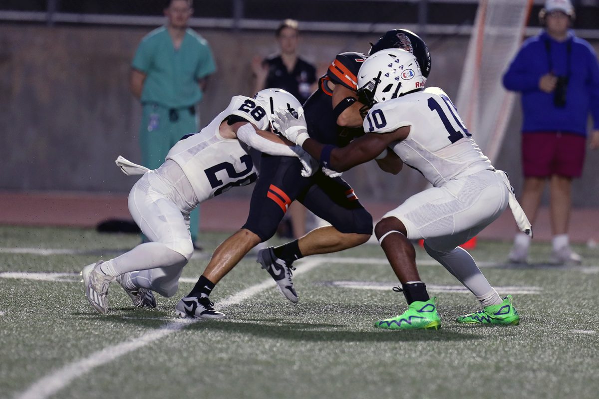 Junior Andy Watts and senior Davion Harris tackle the opponent.
