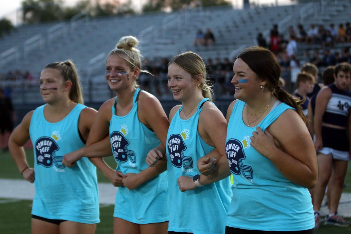 Walking to the captains meeting seniors Olivia Kerstetter, Megan Kephart, Keira Franken,  Kathryn Yockey smile. 
