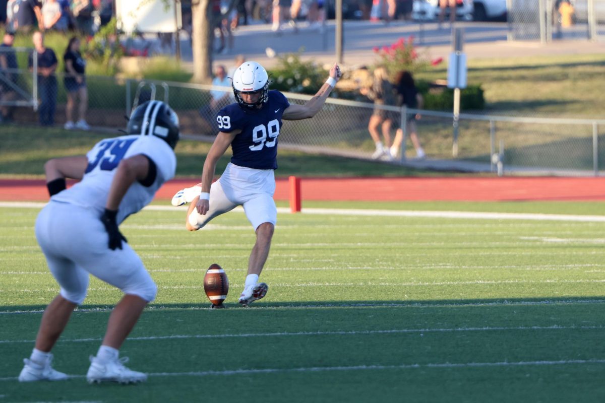 Winding up, senior Kenten Laughman prepares for the fist kickoff of the season.