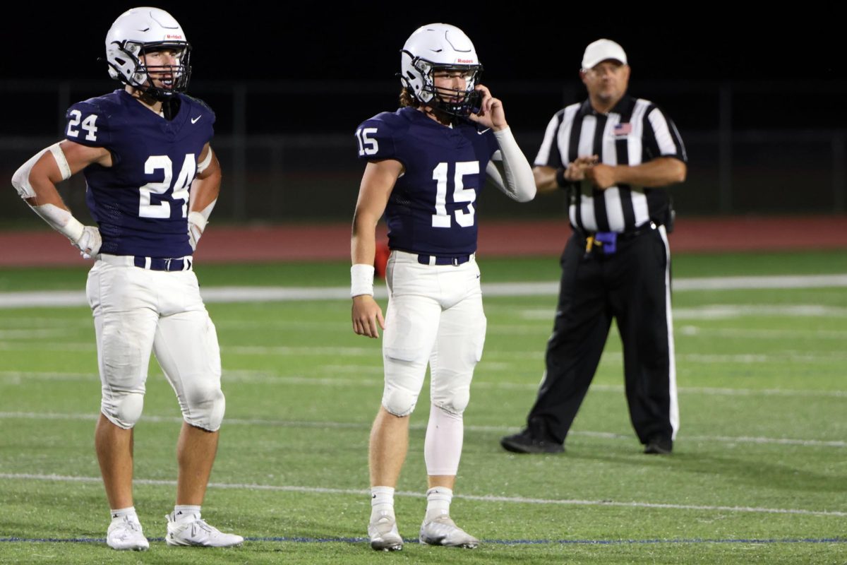 Seniors Jaden Scobee and Daniel Blaine look to the sideline for the play call. 