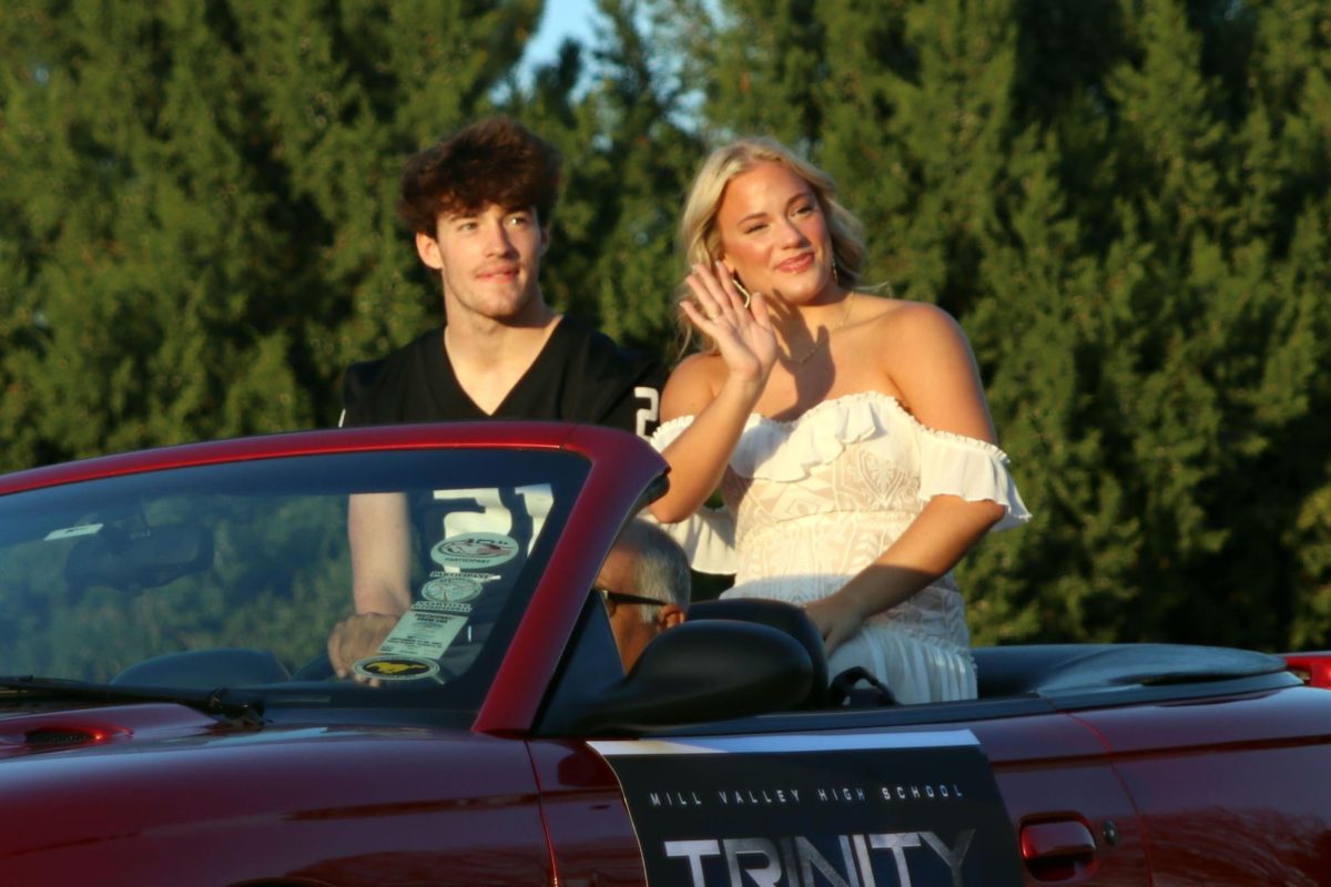With smiles on their faces homecoming king and queen candidate Trinity and Tristan Baker wave to the crowd. 