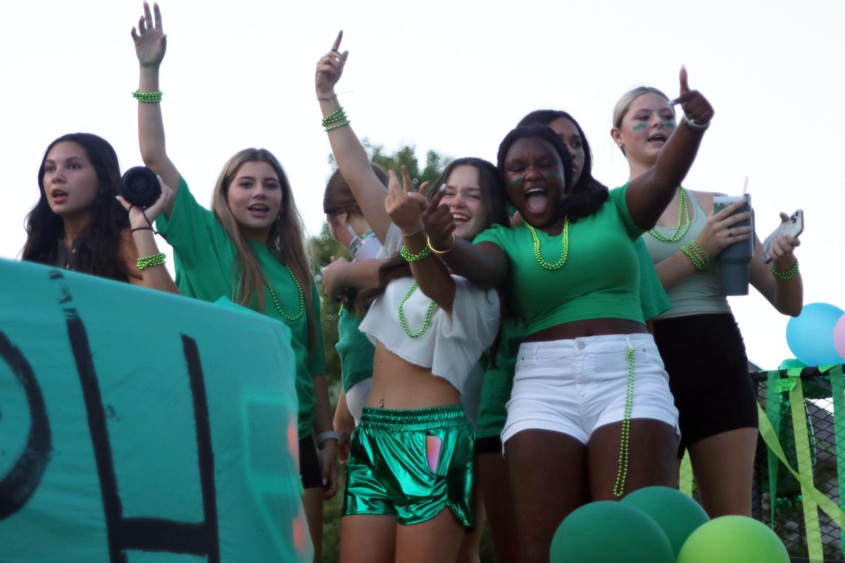 Sophomores Evie Grover, Annie Newell, and Esther Kisivo dance on the sophomore float. 