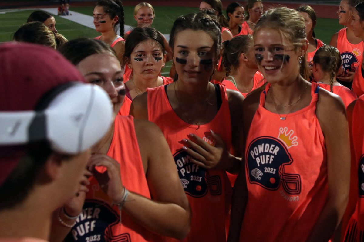 Before the play, juniors Seville Skinner and Calista Marx listen to the play call.