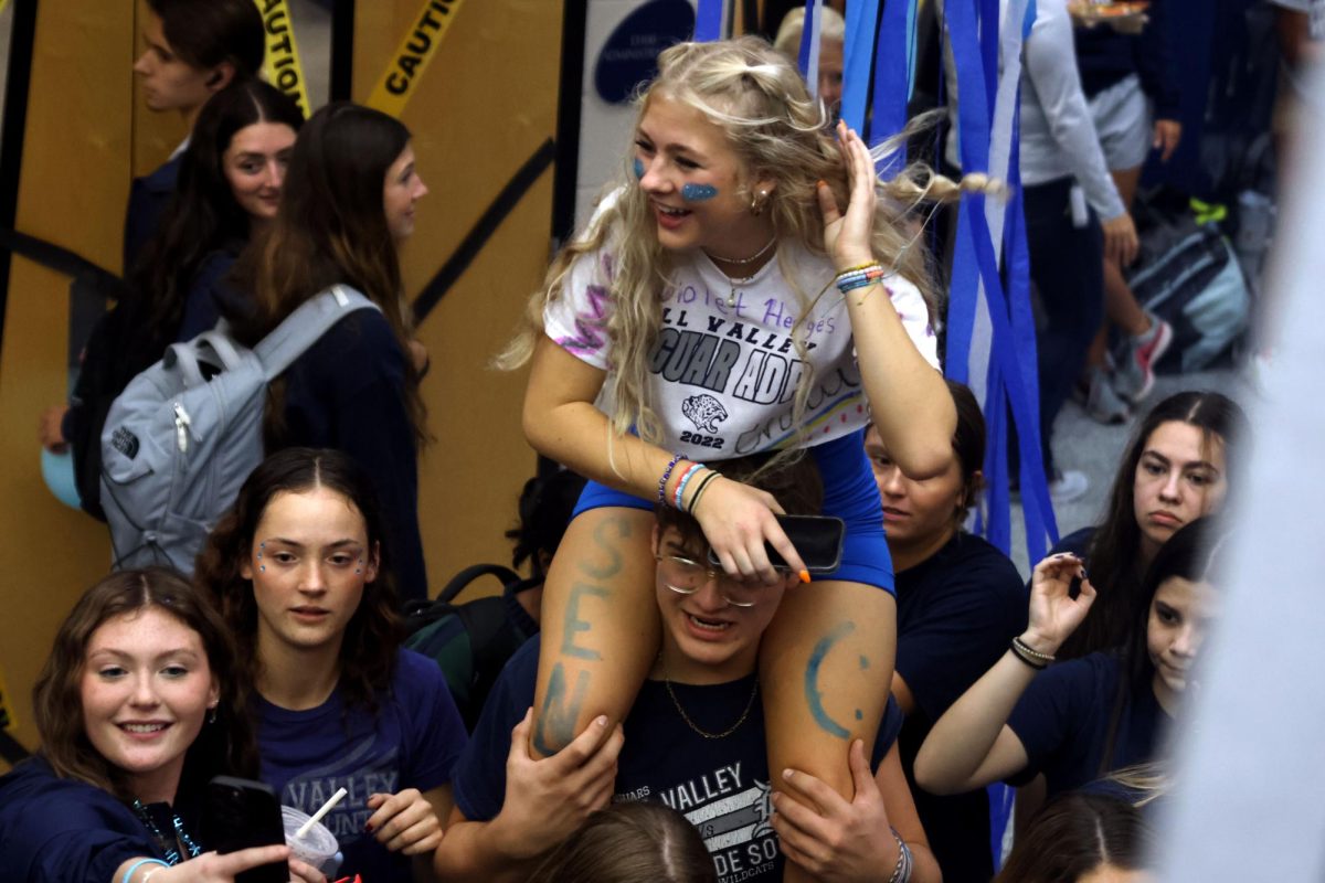 After dancing, senior Violet Hentges sits on senior Blake Powers shoulders. 