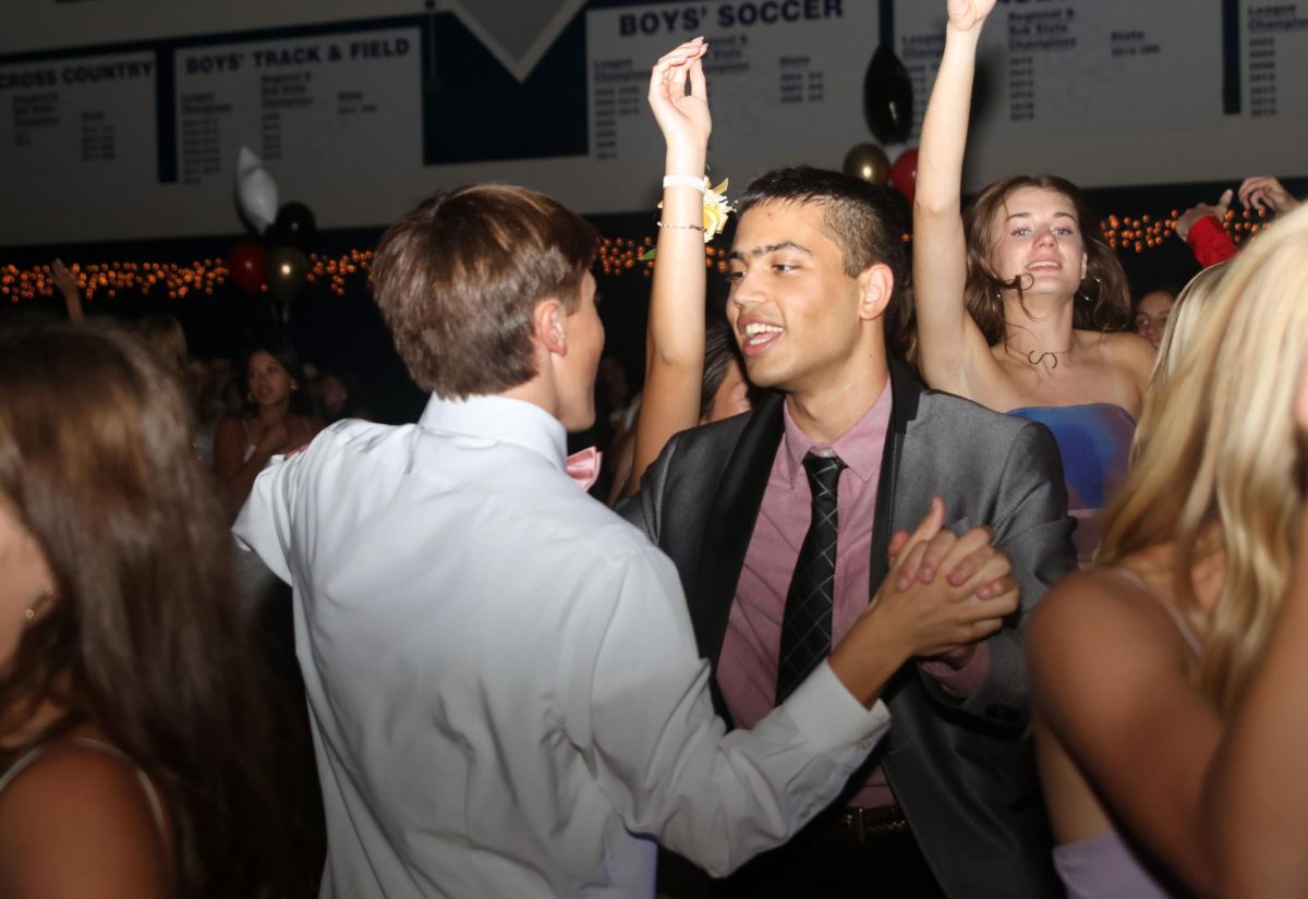 Sophomore Gavin Hurt dances with junior Boji Green. 