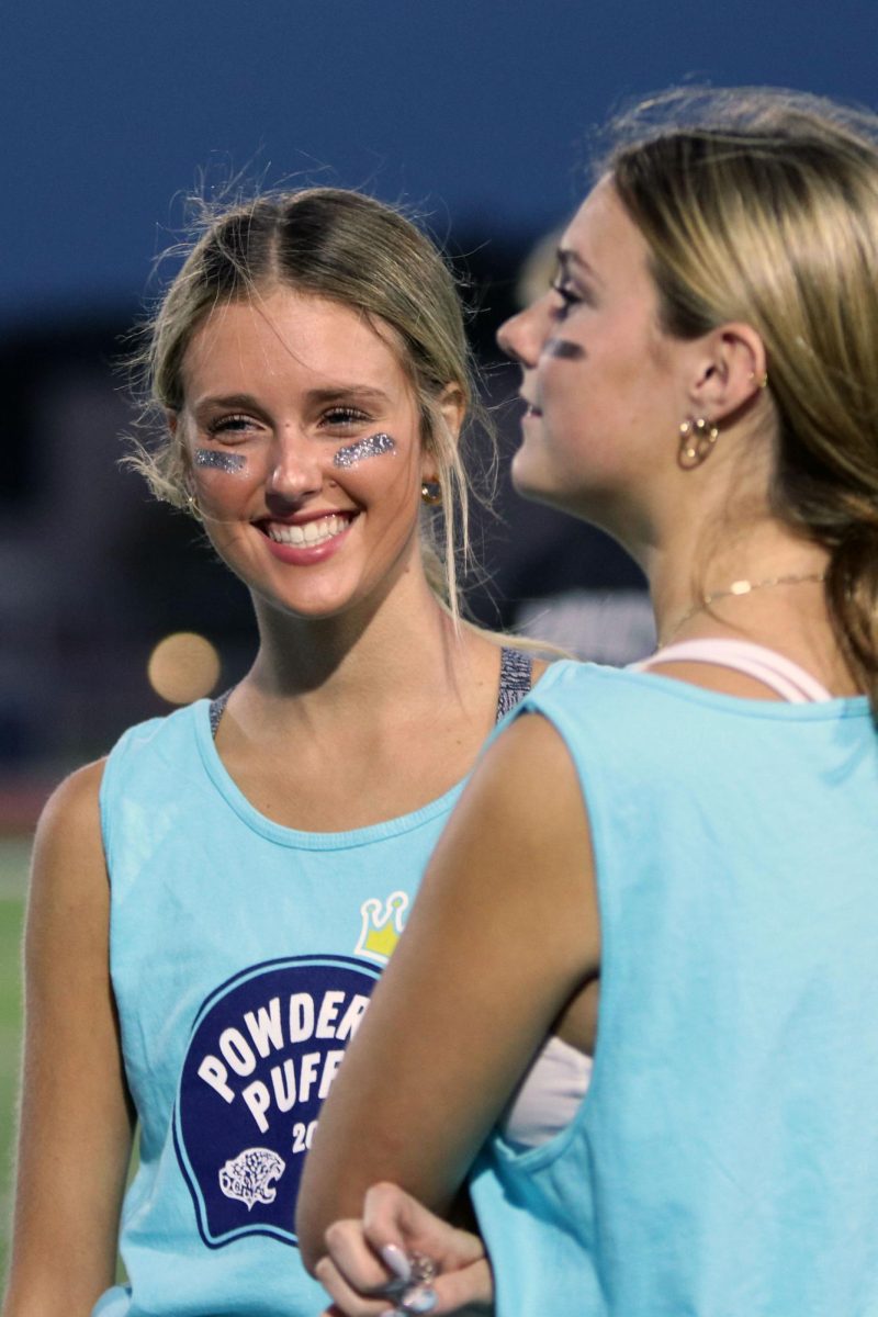 After the seniors victory, senior Gracie Bowline smiles with her teammates.