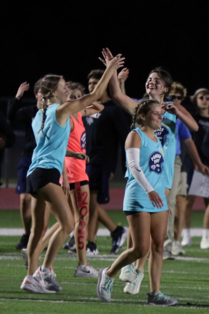 Seniors Hailee Ford and Madi Angell high five after a successful play.
