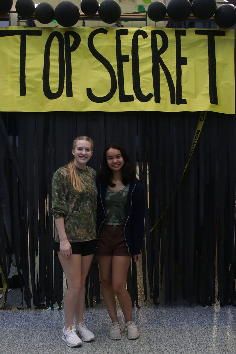 Posing in their best camo outfits, seniors Renee Steinle and Peyton Aucoin enjoy their last homecoming week. 