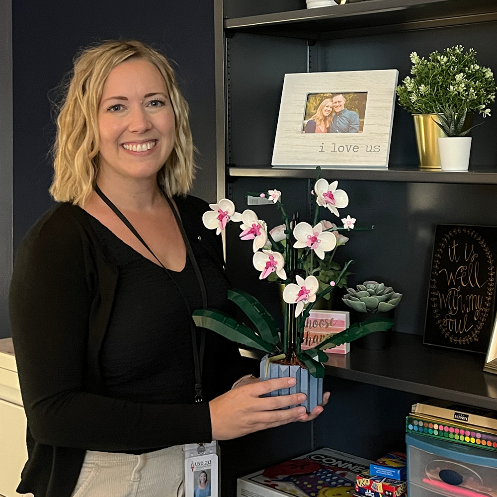 Newly hired school psychologist Stacy Miller poses with Lego flowers she and her son built together Monday, Sep. 4. “[They] remind me of our shared interest in Legos and how much I love my kids,” Miller said.