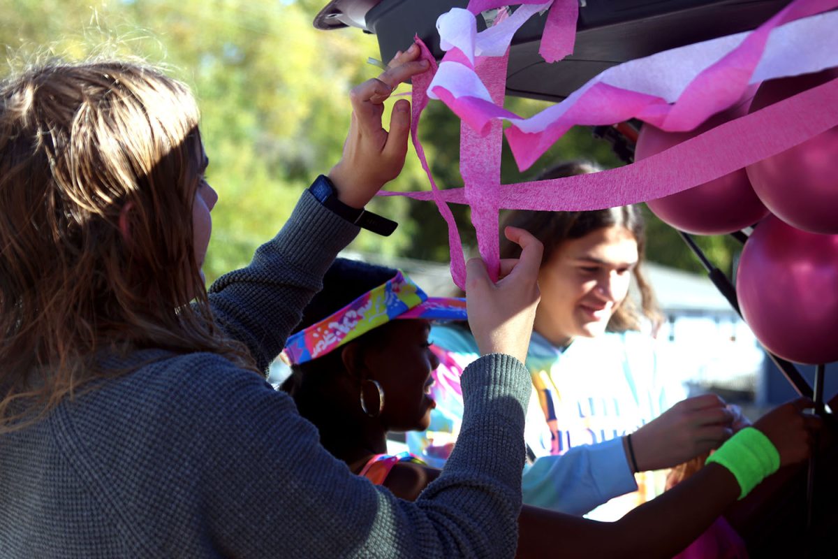 Sophomores Will Schieber, Tristyn Jones and Keegan Wootton work together to decorate their trunk for the KCIA trunk or treat.