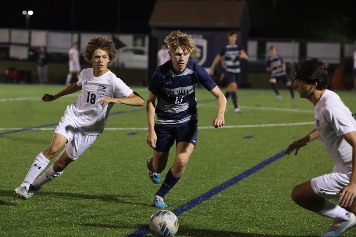 Junior Drew Enloe tries to get the ball back from the other team.