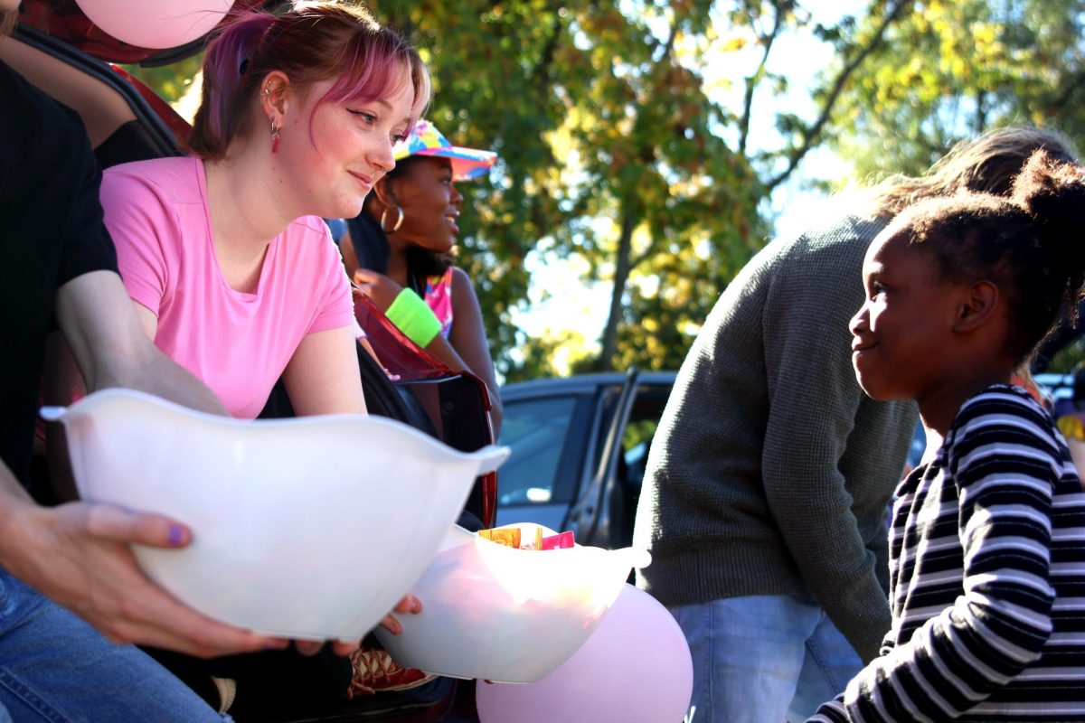 Looking at each other, senior Emma Clement and KCIA student smile.