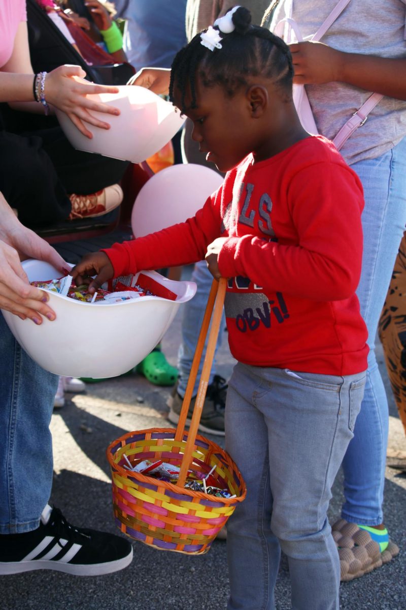 A KCIA student chooses candy from the bowl.