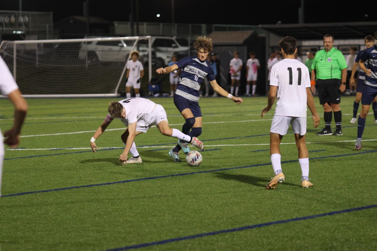Stealing the ball, junior Nic Schrag fights his defender. 