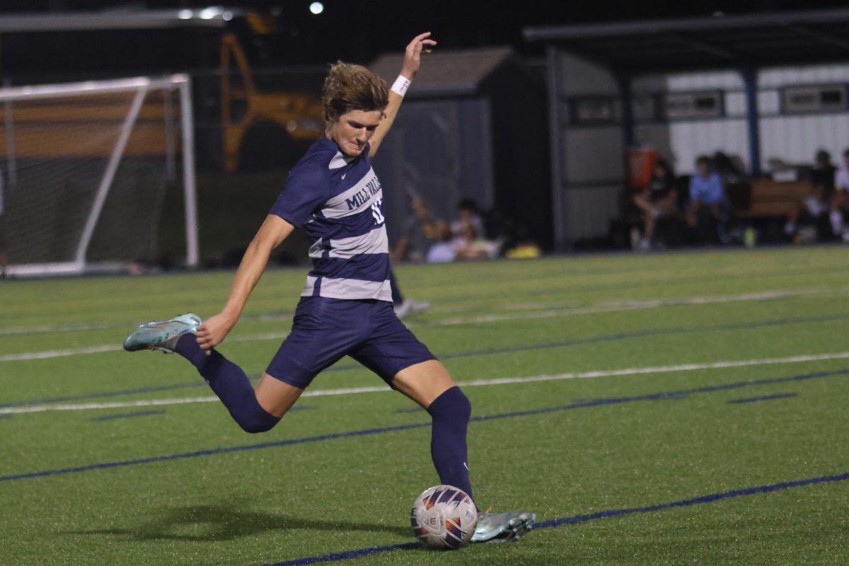 Focused, junior Nic Schrag prepares to kick the ball.