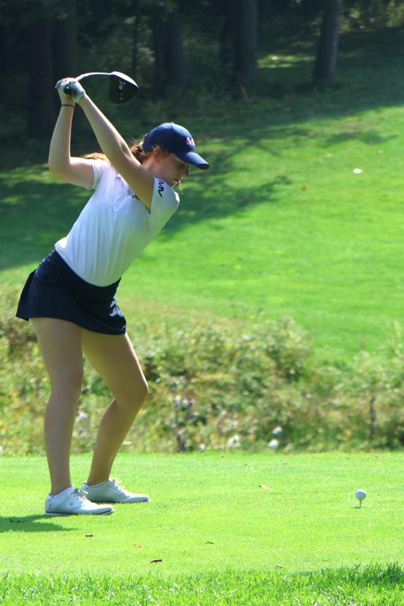 Eyes on the ball, sophomore Sophie Van Inwegen prepares to tee off. 
