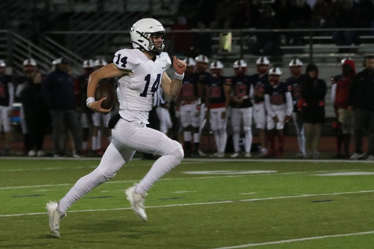 Eyes on the endzone, junior Connor Bohon is on his way to score the first touchdown of the game.