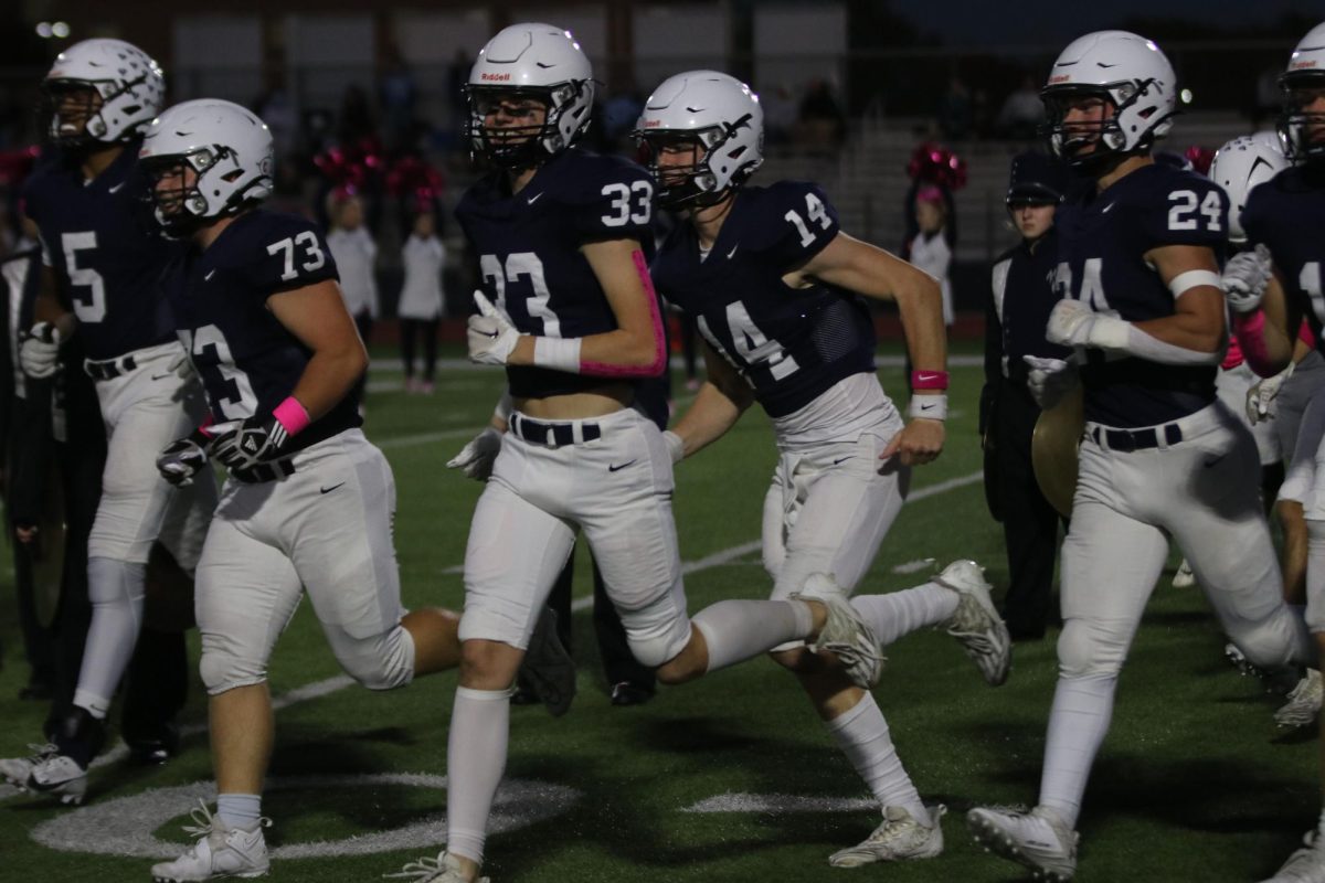 Changing offense and defense, players run back to the sideline with smiles on their faces.