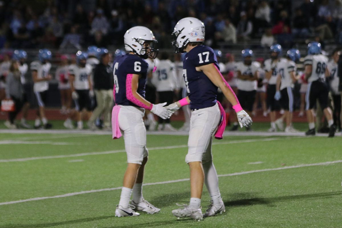 After a play, seniors Jackson Lawler and Haden Applebee share a highfive. 