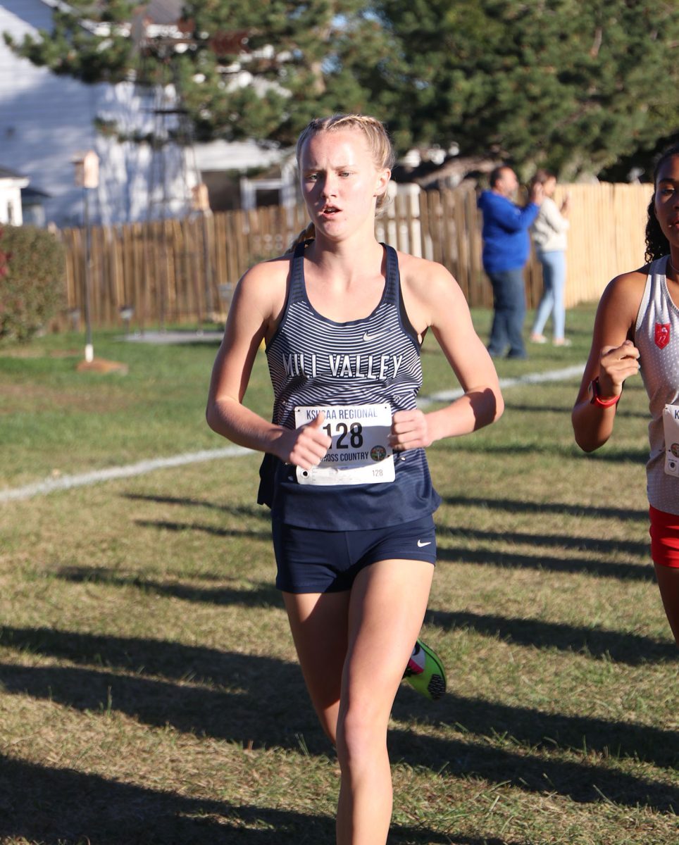 Staying focused, junior Charlotte Caldwell runs against her opponent.