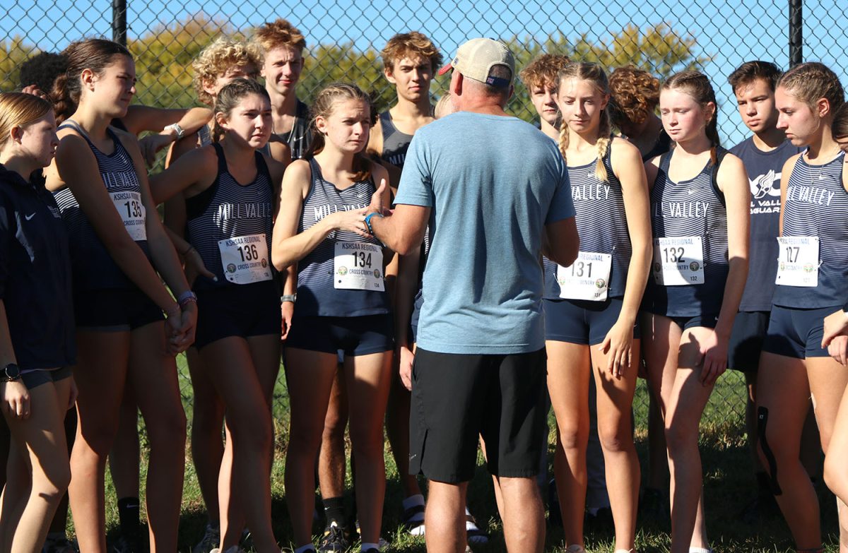 Head coach Chris Mcafee talks to the team after their races. 