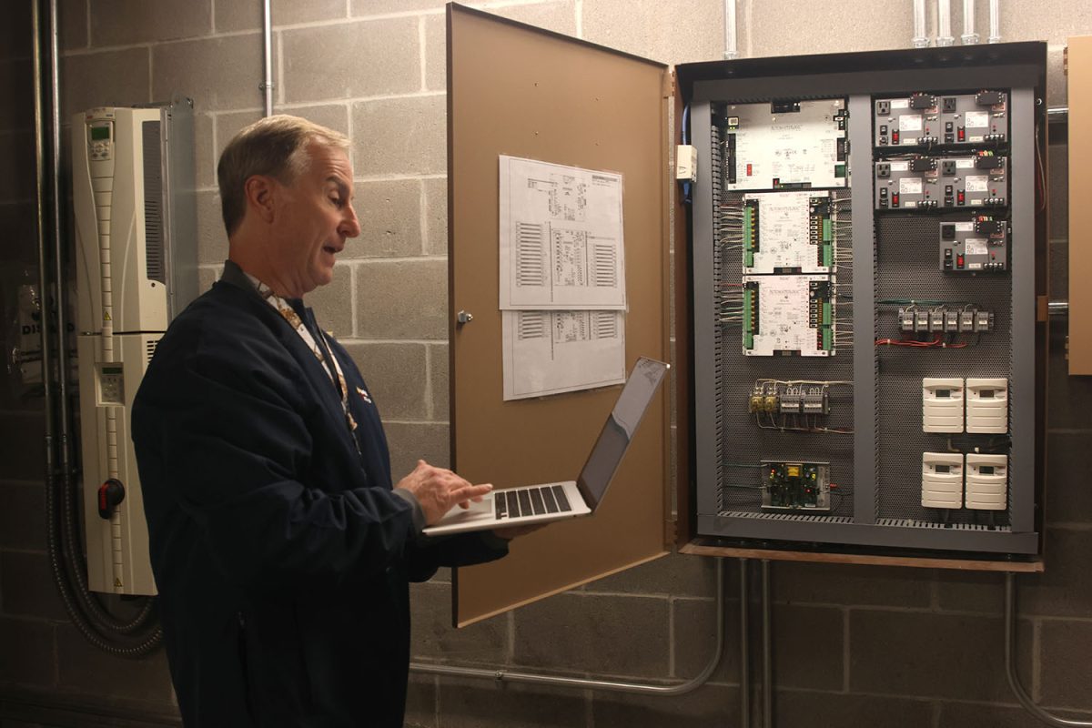 Focusing on the Macbook in his hand, Brian Rodkey explains what he does in the mechanic room.