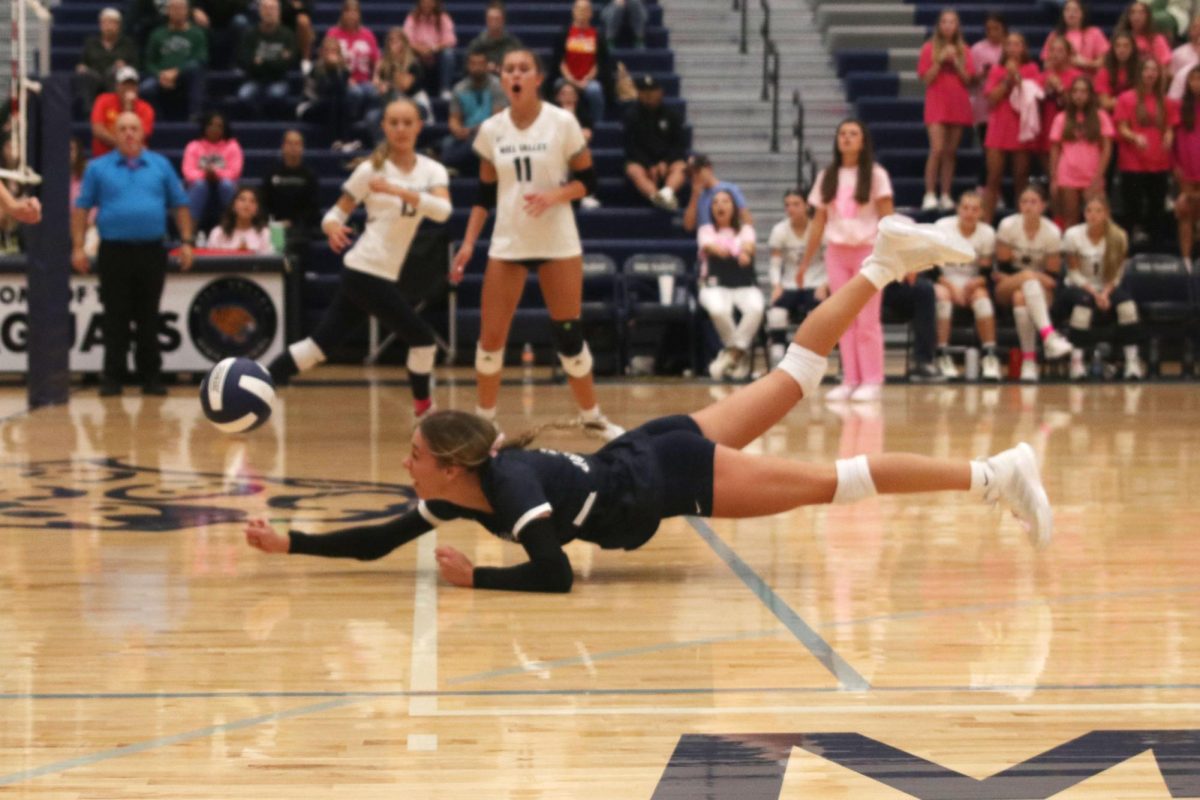 Sophomore Corinne Schwindt dives to keep the ball in play.